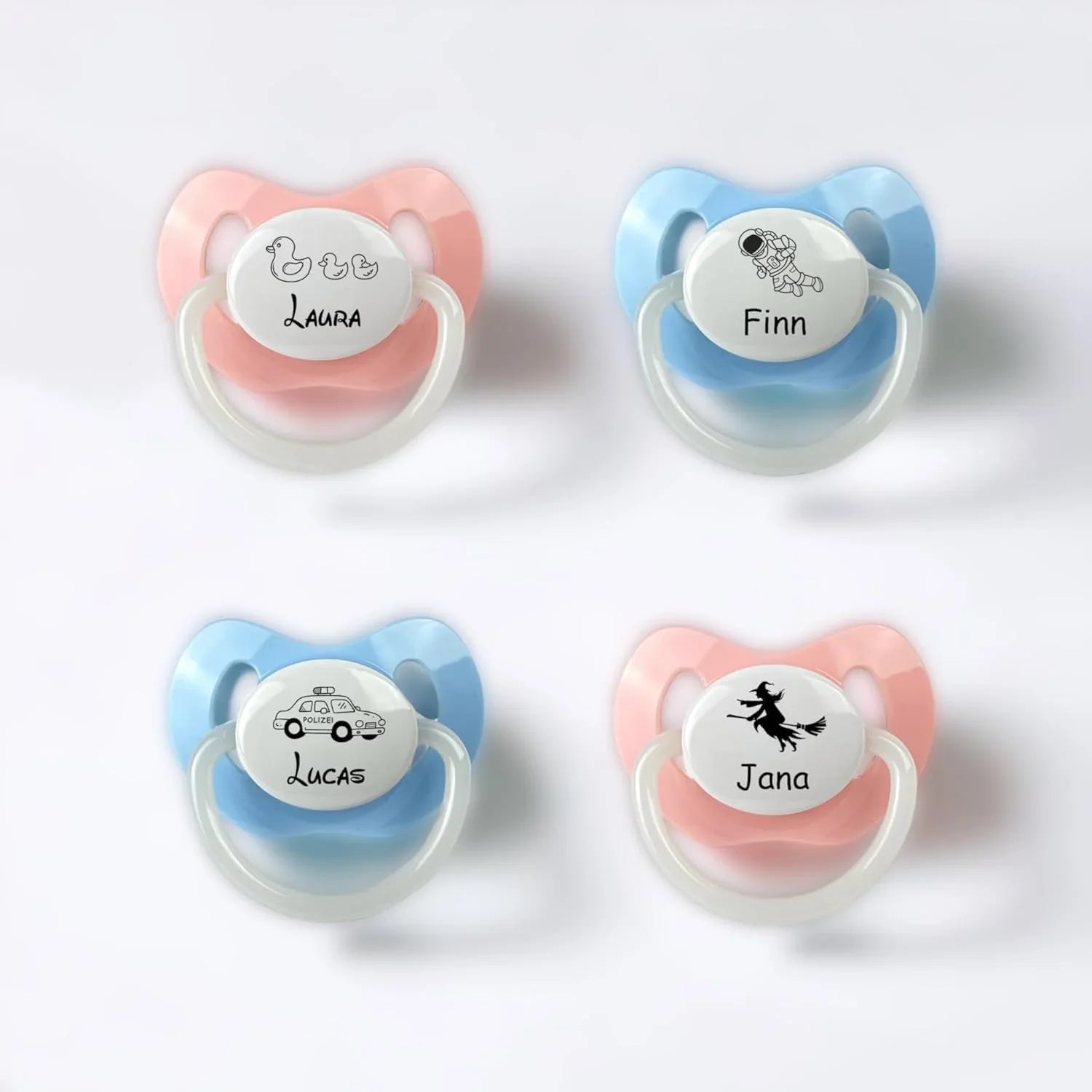 Schnuller in rosa und blau mit Gravur